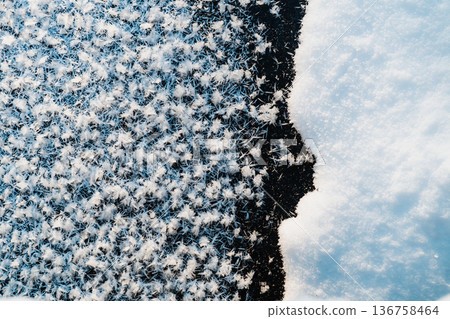 Winter frost ice crystals on dark surface with snow, abstract cold texture background 136758464