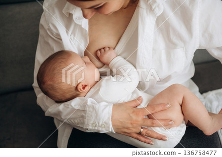Breast feeding. Woman is with her little toddler baby daughter 136758477