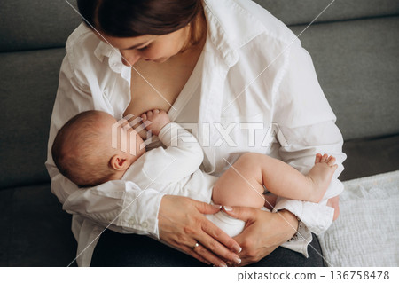 Breast feeding. Woman is with her little toddler baby daughter 136758478