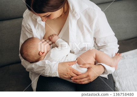 Breast feeding. Woman is with her little toddler baby daughter 136758480