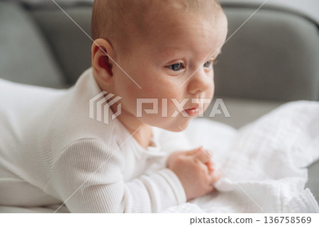 On the sofa. Cute little baby is lying down On the sofa. Cute little baby is lying down 136758569