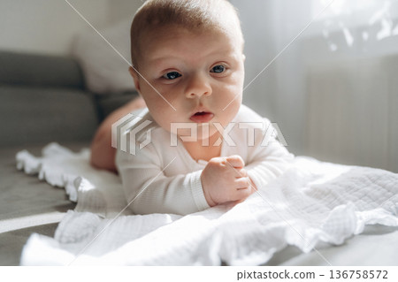 On the sofa. Cute little baby is lying down On the sofa. Cute little baby is lying down 136758572