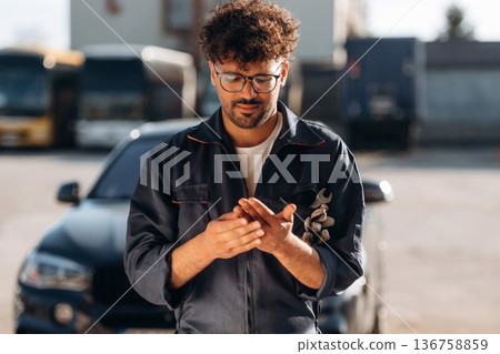 Work is done. Mechanic is with the car outdoors Work is done. Mechanic is with the car outdoors 136758859