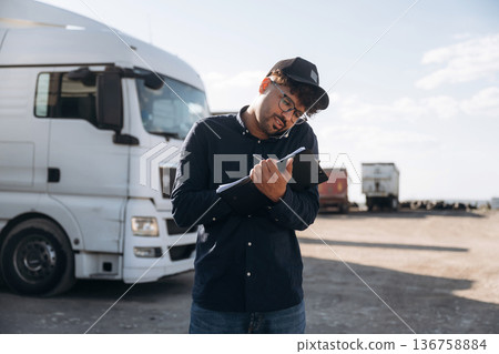 Male worker is near truck outdoors Male worker is near truck outdoors 136758884