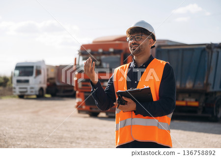 Male worker is near truck outdoors Male worker is near truck outdoors 136758892