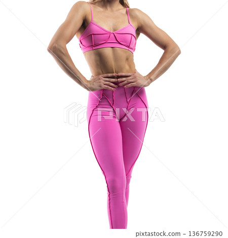 Athletic woman posing in pink sports bra and leggings with transparent background 136759290
