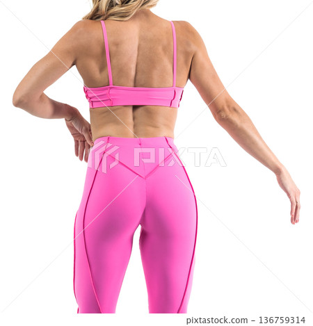 Athletic woman posing in pink sports bra and leggings with transparent background 136759314