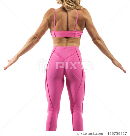 Athletic woman posing in pink sports bra and leggings with transparent background 136759317
