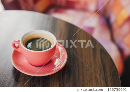 Cup of black coffee on a table in a cafe. \ 136759691