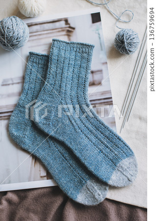 Hand knitted socks with needles and yarn balls. Concept for handmade and hygge slow life. 136759694