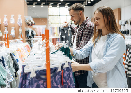 Together in the in the kid's clothing store. Pregnant woman with man 136759705