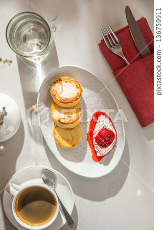 Cheesecakes with berry sauce and sour cream 136759911