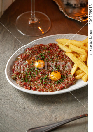 Beef tartare with egg yolk and french fries Beef tartare with egg yolk and french fries 136759918