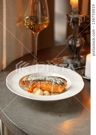 Pan seared salmon with creamy sauce 136759919