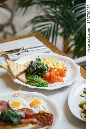 Breakfast plate with omelette salmon avocado toast 136759981