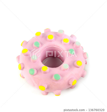 Pink donut-shaped rubber dog toy with colorful bumps isolated on white 136760320
