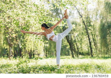 Practicing the asana. Beautiful fitness yoga woman is outdoors, amazing nature 136760459
