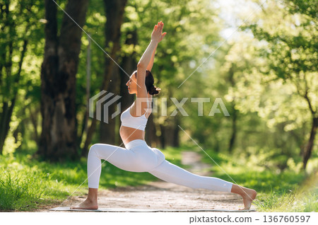 Exercises for flexibility. Beautiful fitness yoga woman is outdoors, amazing nature 136760597