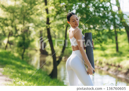 Near the river. Beautiful fitness yoga woman is outdoors, amazing nature Near the river. Beautiful fitness yoga woman is outdoors, amazing nature 136760605