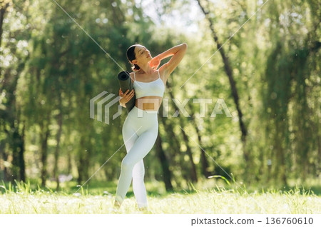Beautiful fitness yoga woman is outdoors, amazing nature Beautiful fitness yoga woman is outdoors, amazing nature 136760610