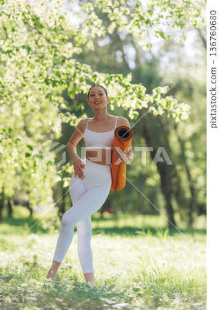 Enjoying nature, standing. Beautiful fitness yoga woman is outdoors, amazing nature Enjoying nature, standing. Beautiful fitness yoga woman is outdoors, amazing nature 136760680