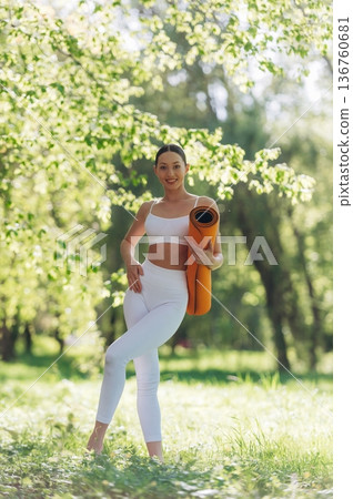 Enjoying nature, standing. Beautiful fitness yoga woman is outdoors, amazing nature 136760681