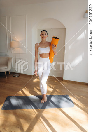 In the domestic room. Young woman in fitness clothes In the domestic room. Young woman in fitness clothes 136761239