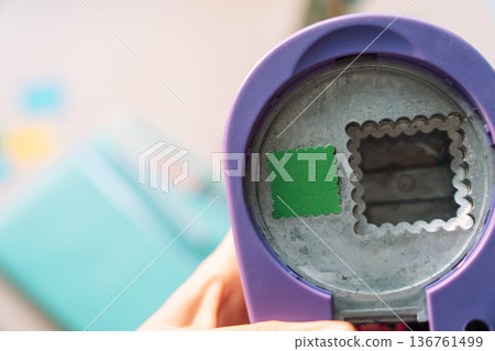 Close up of a craft paper punch tool for cutting decorative shapes, creative hobby and paper craft concept Close up of a craft paper punch tool for cutting decorative shapes, creative hobby and paper craft concept 136761499