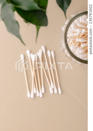 Bamboo cotton swabs arranged in row and in glass jar, top view. They symbolize eco-friendly beauty, zero-waste production, and natural hygiene products. Environmental awareness and green lifestyle Bamboo cotton swabs arranged in row and in glass jar, top view. They symbolize eco-friendly beauty, zero-waste production, and natural hygiene products. Environmental awareness and green lifestyle 136761602