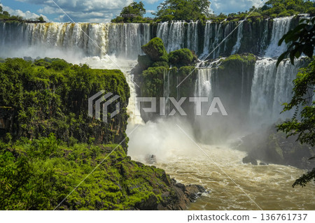 Boat zodiac taking tourist under the Iguazu falls waterfalls Scenic destination in Argentia Boat zodiac taking tourist under the Iguazu falls waterfalls Scenic destination in Argentia 136761737