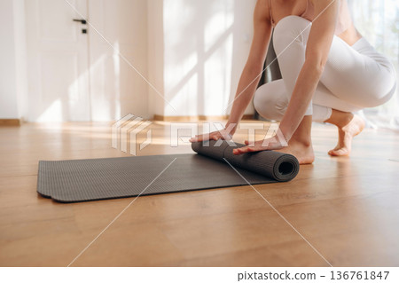 Preparing, with mat. Yoga time, close up view of woman that is practicing at home Preparing, with mat. Yoga time, close up view of woman that is practicing at home 136761847