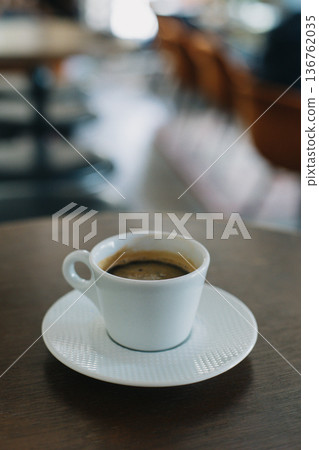 Cup of black coffee on a table in a cafe. Selective focus. 136762035
