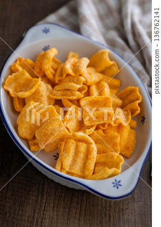 Crispy salted chips on wooden table. Crispy salted chips on wooden table. 136762141