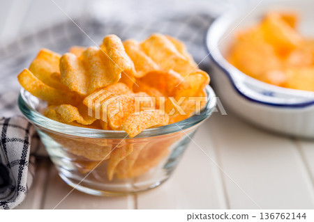 Crispy salted chips in bowl on white table. 136762144