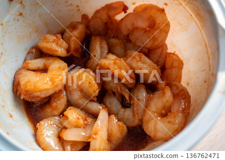 Close-up of Raw Shrimp Marinating in a Savory Sauce 136762471