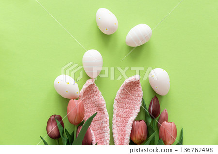 Easter Eggs with Bunny Ears and Tulips on Green Background. Spring Holiday Composition 136762498