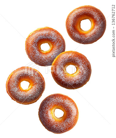 Multiple golden brown glazed donuts with powdered sugar isolated on white background. Concept of sweet treats 136762712