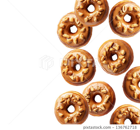 Top view of multiple maple glazed donuts with chopped pecans, isolated on white background, concept of sweet pastry pattern 136762718