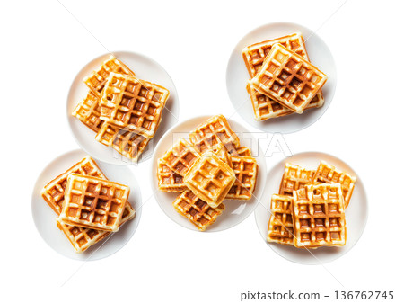 Multiple plates of golden waffles with creamy topping isolated on white background, concept of delicious breakfast food 136762745