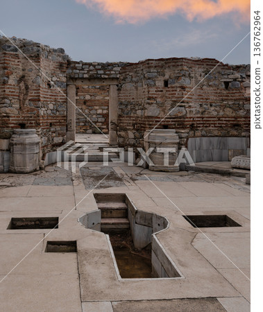 Ruins of the Basilica of St John with ancient baptismal font under a colorful sky, Selcuk, Turkey 136762964