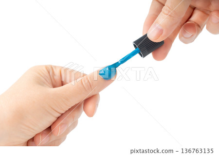 Applying nail polish in close-up. Getting manicures on your own at home 136763135