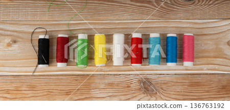 Needle and thread. Needlework object, color cotton thread spool and needle Needle and thread. Needlework object, color cotton thread spool and needle 136763192
