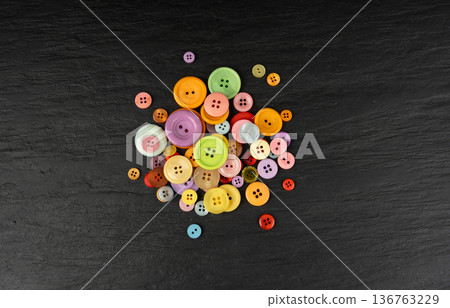 Multicolored sewing buttons. Plastic sew buttons of different colors and sizes Multicolored sewing buttons. Plastic sew buttons of different colors and sizes 136763229