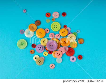 Multicolored sewing buttons. Plastic sew buttons of different colors and sizes 136763231