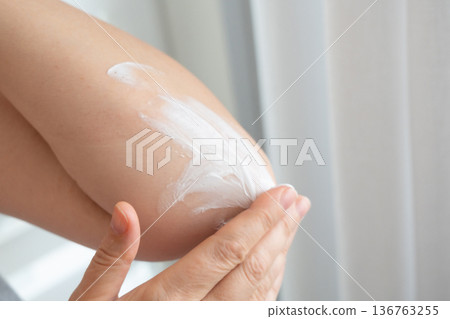 Cream on elbow skin. Applying the lotion to dry rough hands skin, elbow moisturizing creme Cream on elbow skin. Applying the lotion to dry rough hands skin, elbow moisturizing creme 136763255