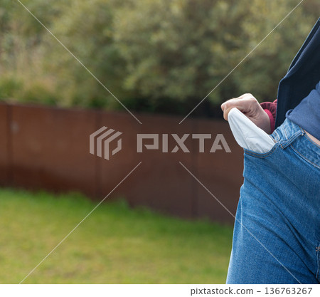Empty pockets close-up. Woman is showing financial loss, no money, poor person Empty pockets close-up. Woman is showing financial loss, no money, poor person 136763267