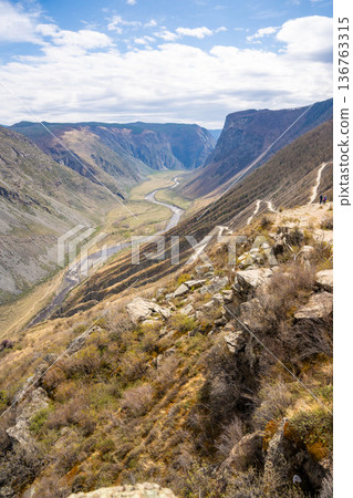 Top view of mountain road leading to Katu Yaryk pass and Chulyshman valley with river in Altai Russia Dramatic highland landscape with winding route and deep canyon 136763315