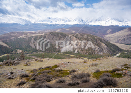 Panoramic view of Kurai Steppe with snow-covered North Chuysky Ridge in Altai Russia. Wide Siberian mountain landscape showcasing winter terrain and open plains. Panoramic view of Kurai Steppe with snow-covered North Chuysky Ridge in Altai Russia. Wide Siberian mountain landscape showcasing winter terrain and open plains. 136763328