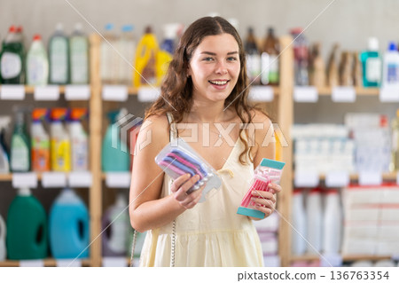 Young woman choosing razor in store Young woman choosing razor in store 136763354