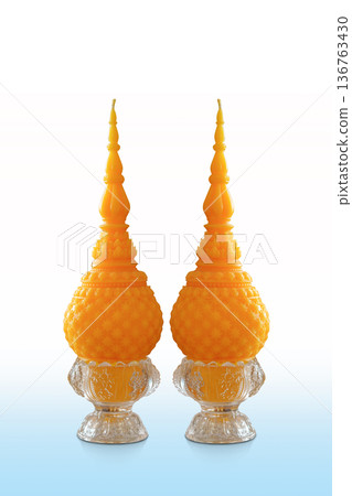 front view beautiful two ceramic glass candle holders and two yellow candles on white and blue background, decor, fashion, religion, object, copy space front view beautiful two ceramic glass candle holders and two yellow candles on white and blue background, decor, fashion, religion, object, copy space 136763430